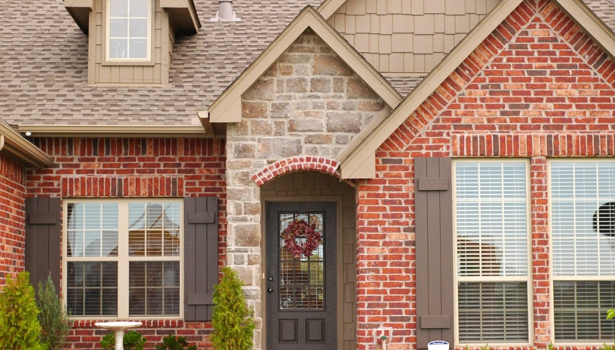 brick home tan roof shingles